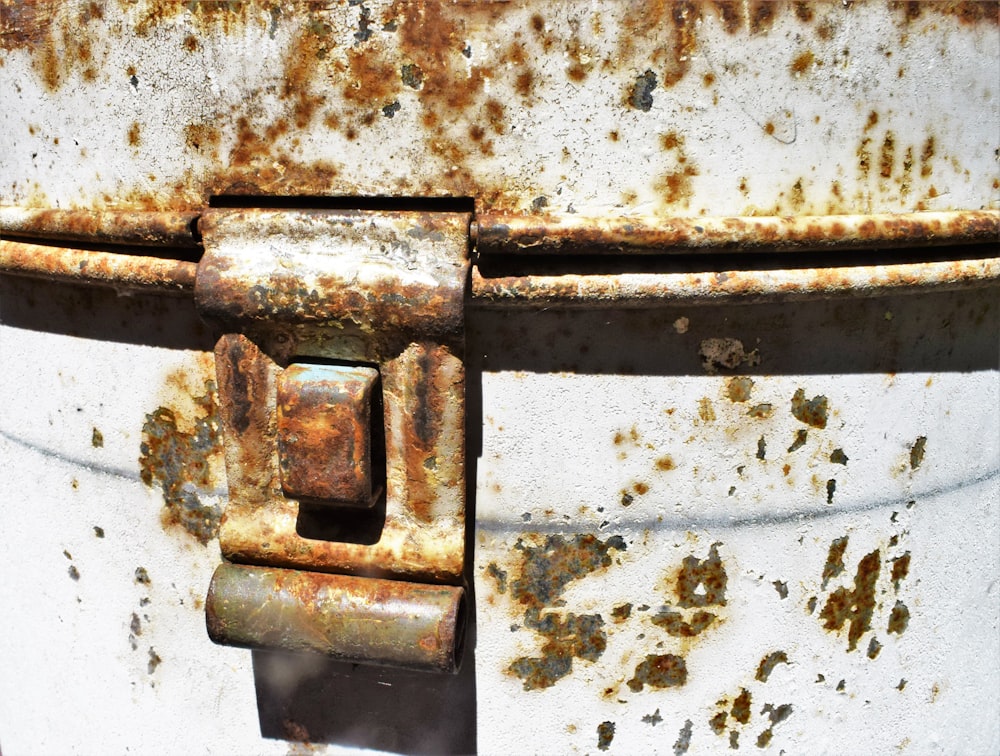 a rusted metal container with a latch