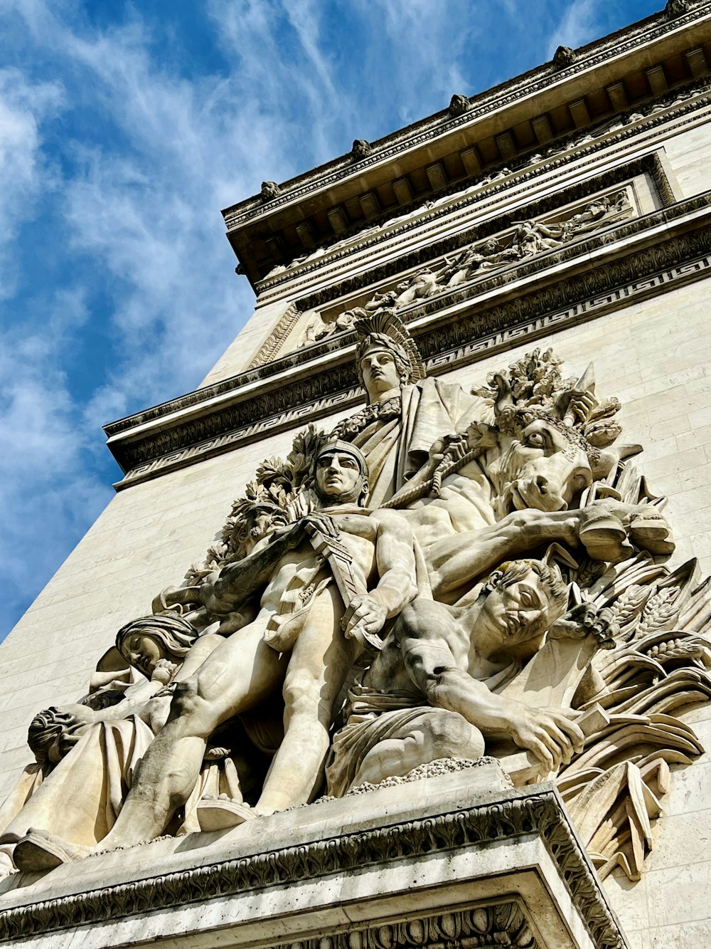 a tall tower with a statue on top of it