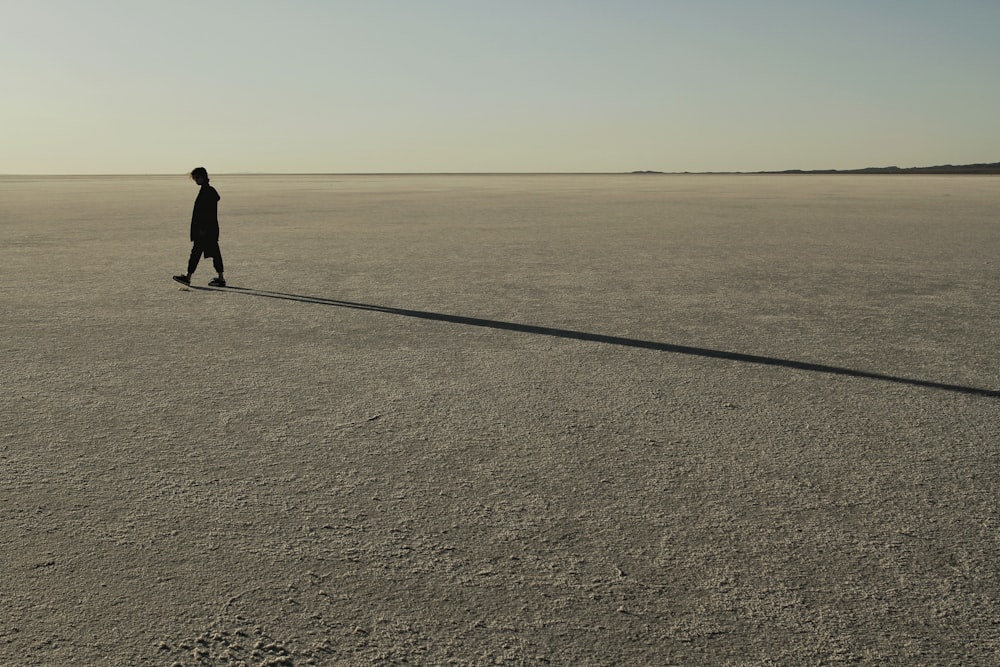 a person walking across a large open field