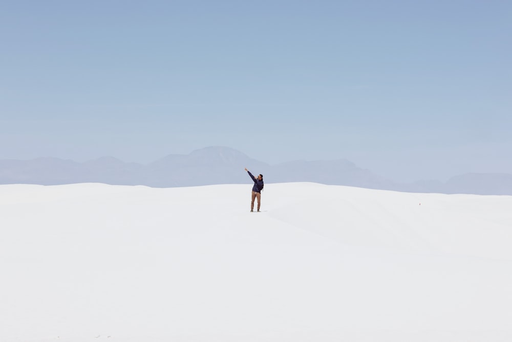 a person standing in the middle of a desert