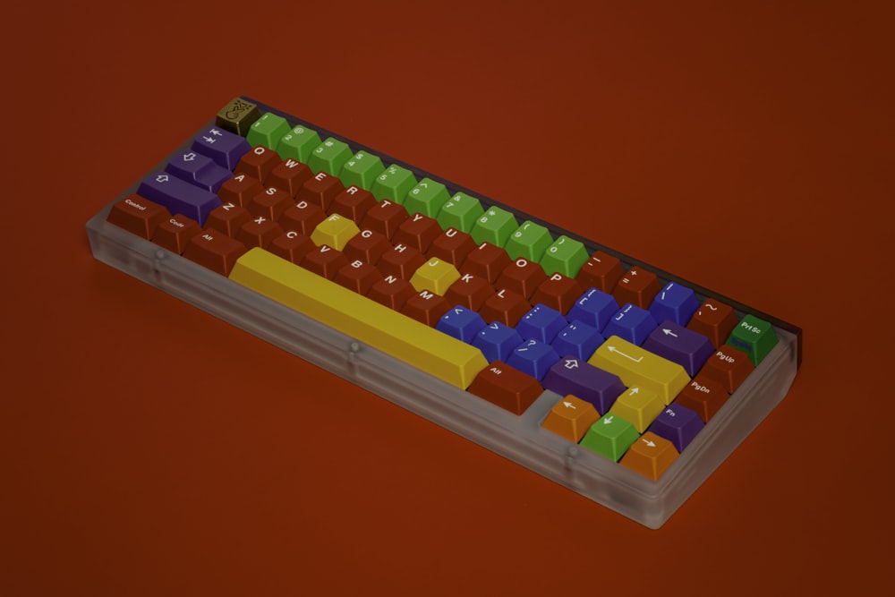 a computer keyboard with colorful keys on a red background