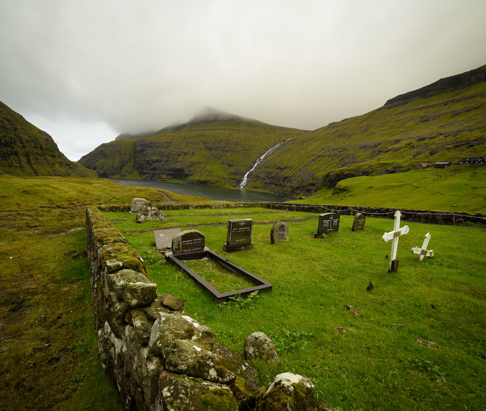 a cemetery in the middle of a grassy field