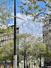 A sleek, eco-friendly building with solar panels in a Parisian neighborhood.