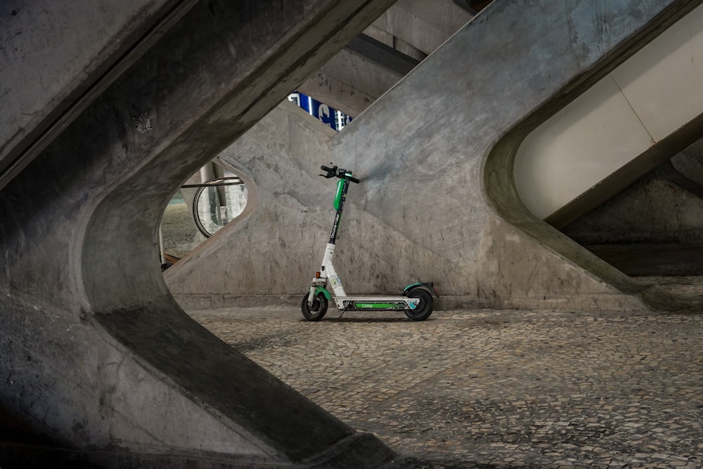 a scooter parked in a parking garage next to a wall
