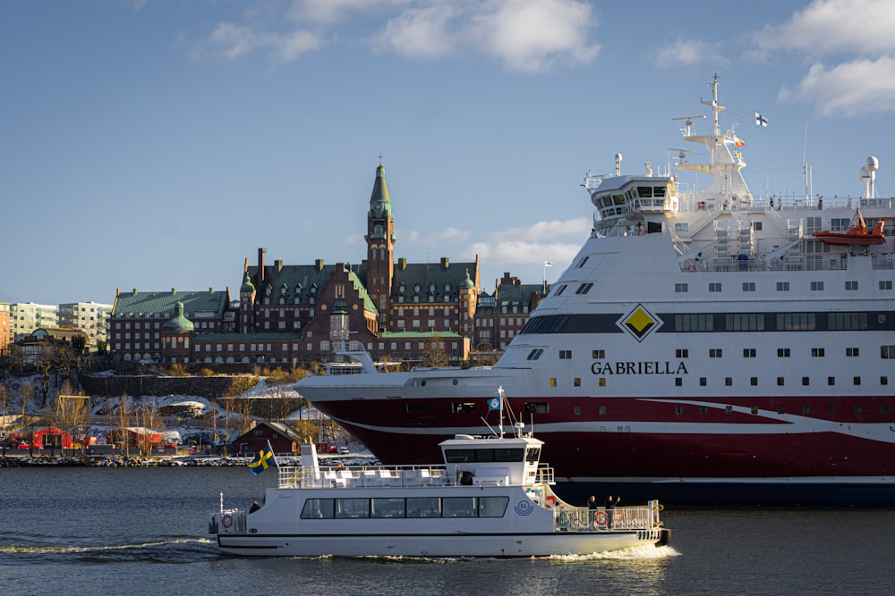 a large cruise ship and a smaller boat in the water