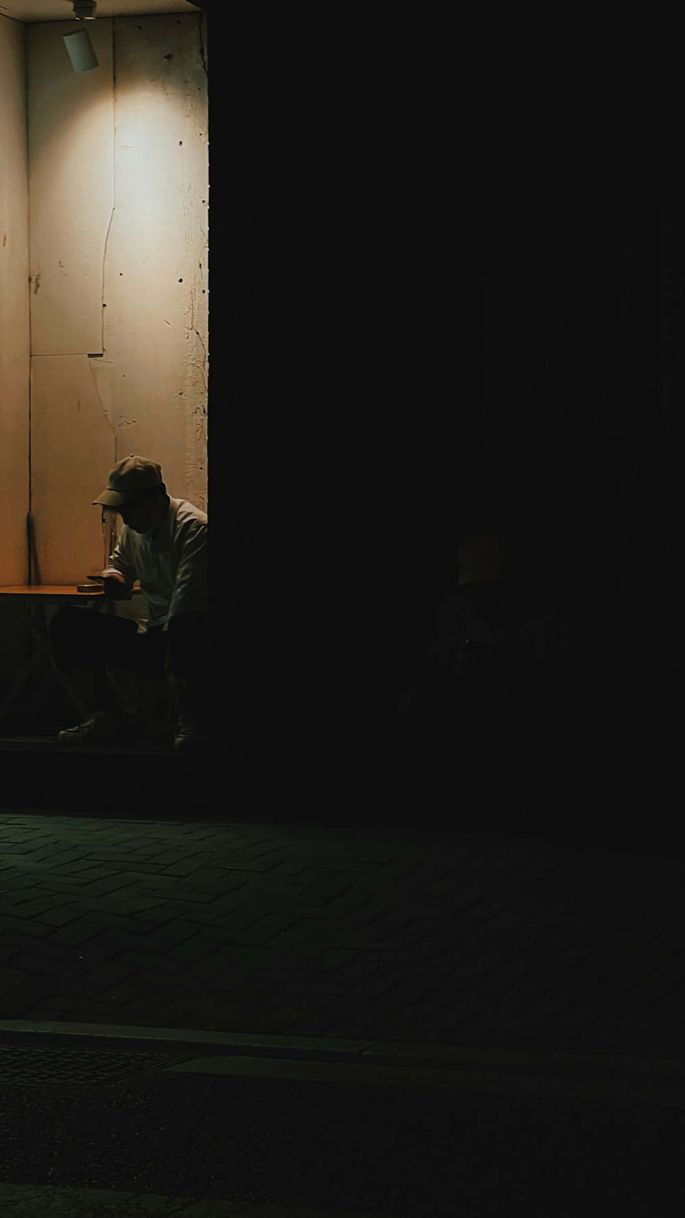 a man sitting on a bed in a dark room