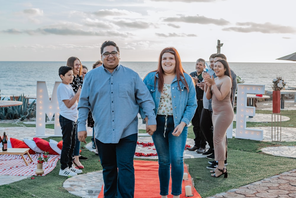 a group of people standing on top of a red carpet