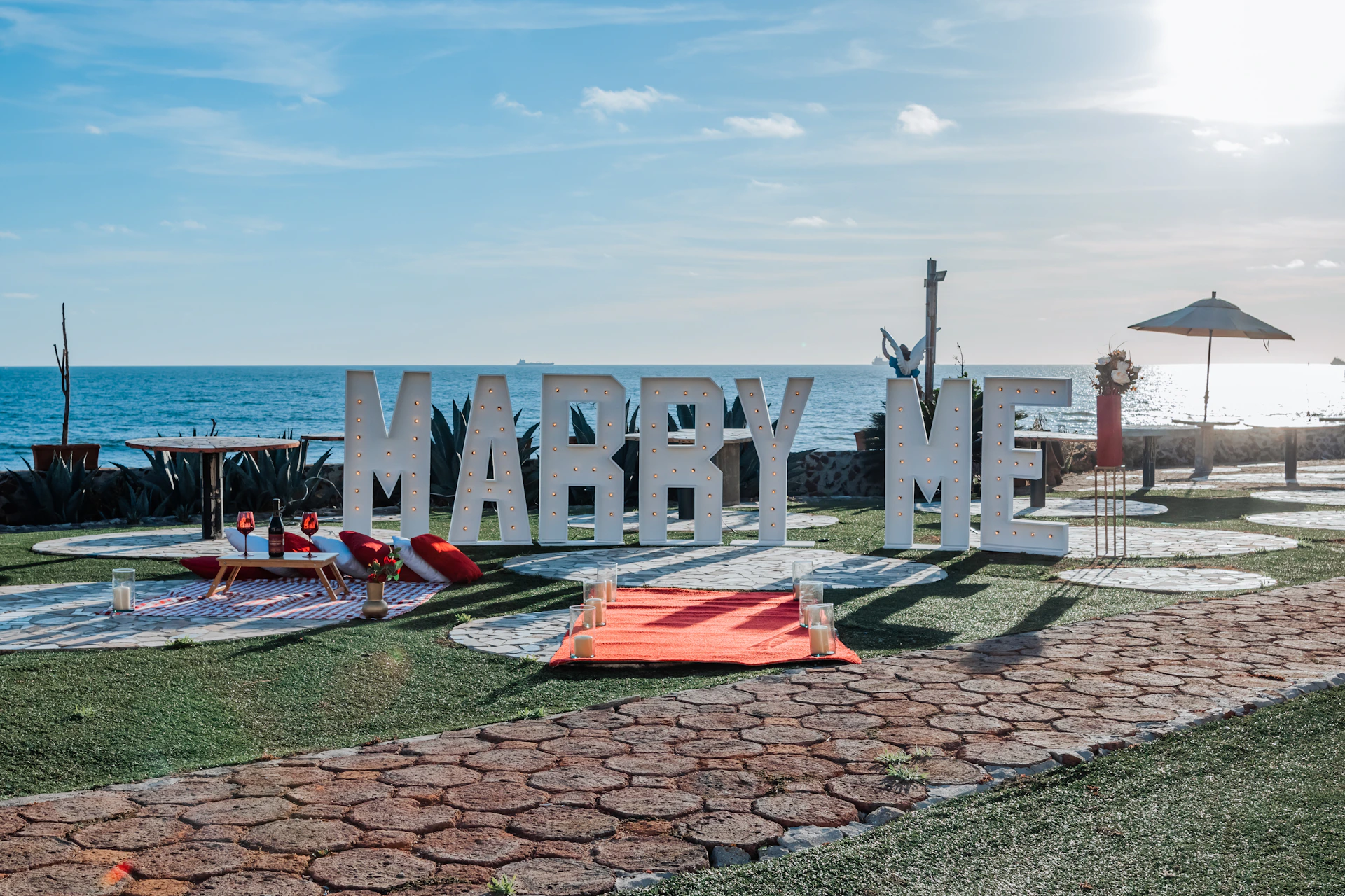 a sign that says marry me in front of the ocean