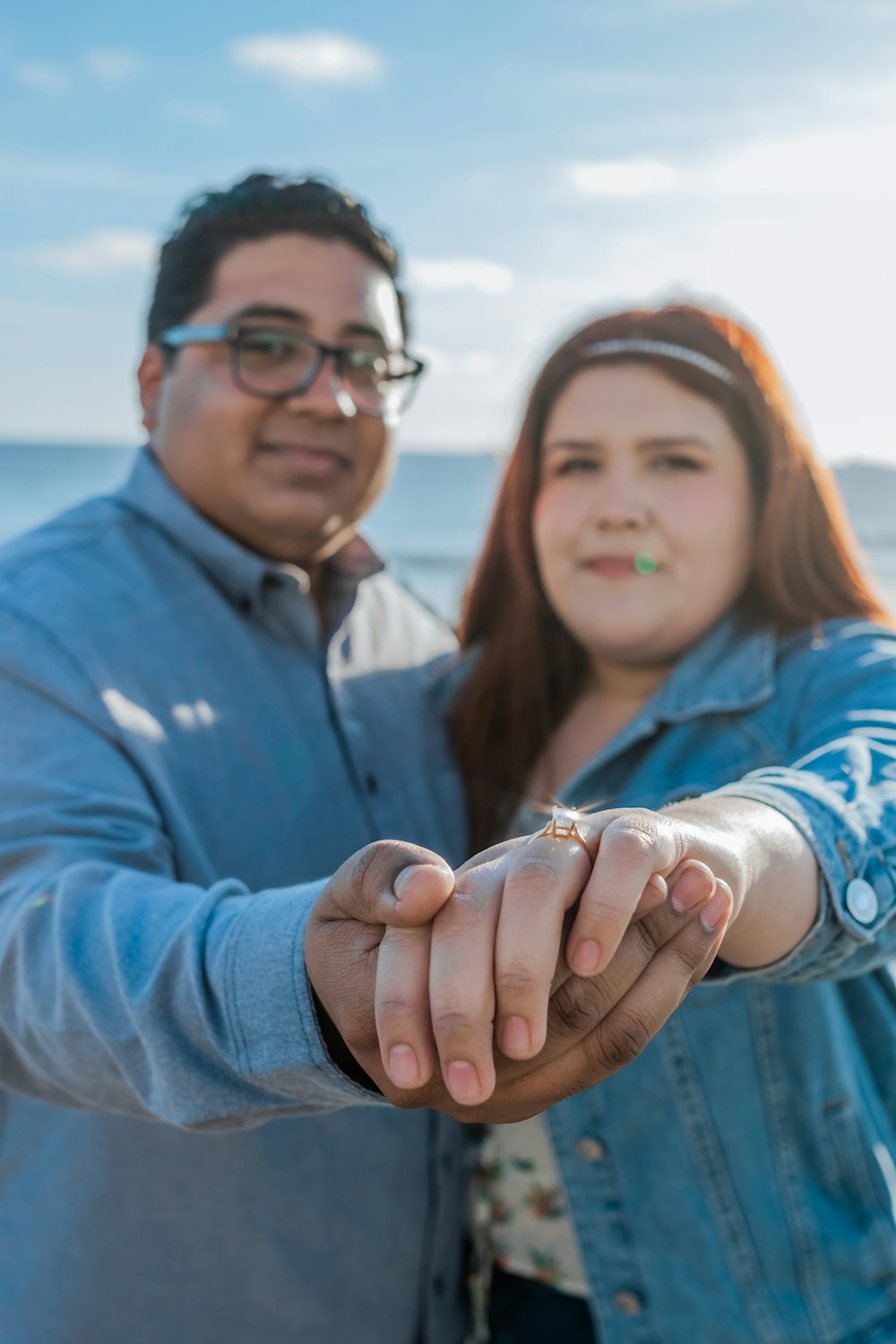 a man and a woman holding hands on a beach