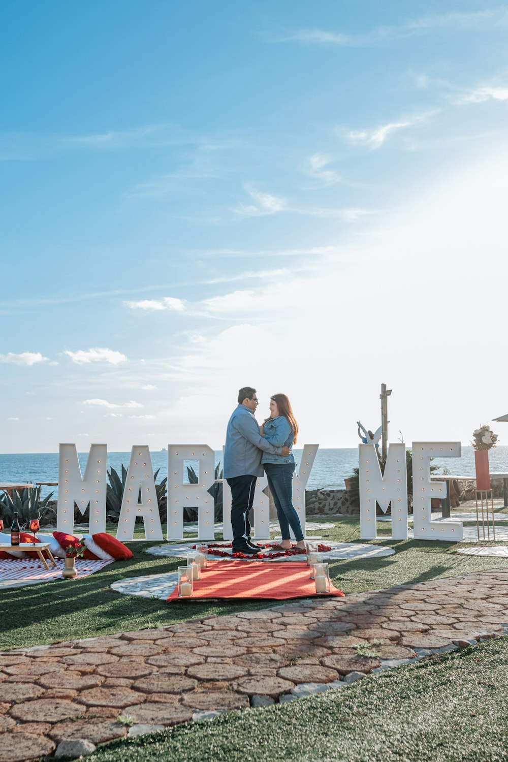 a man and woman standing in front of a sign