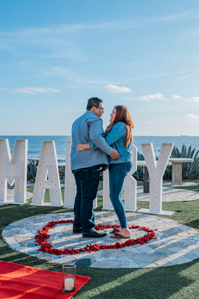 a man and woman standing in front of a sign that says marry