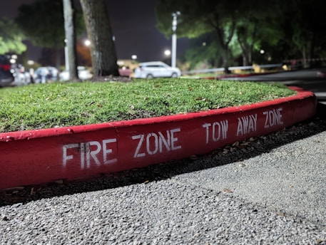 a red fire zone sign curb lines