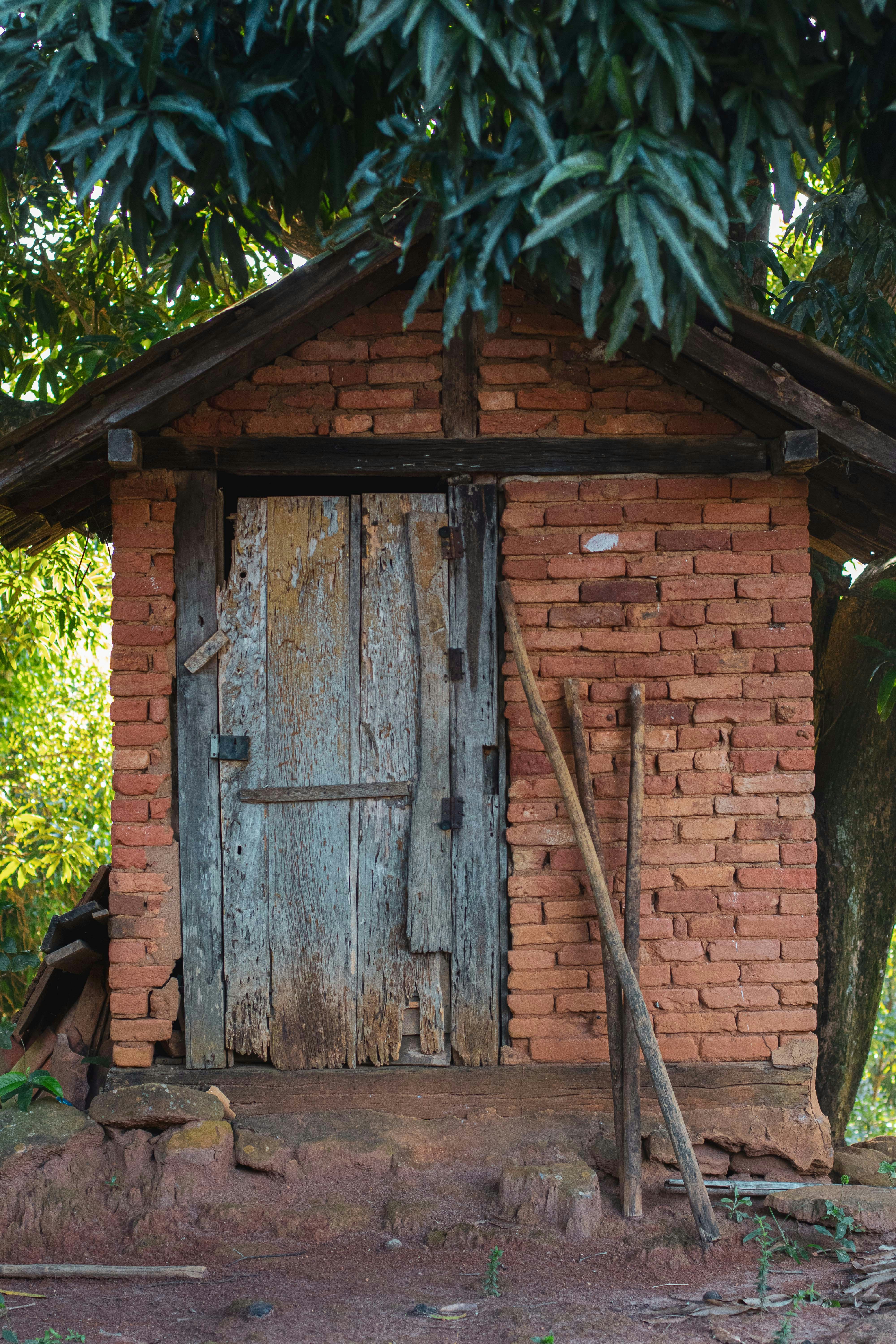 a small brick building with a door and window