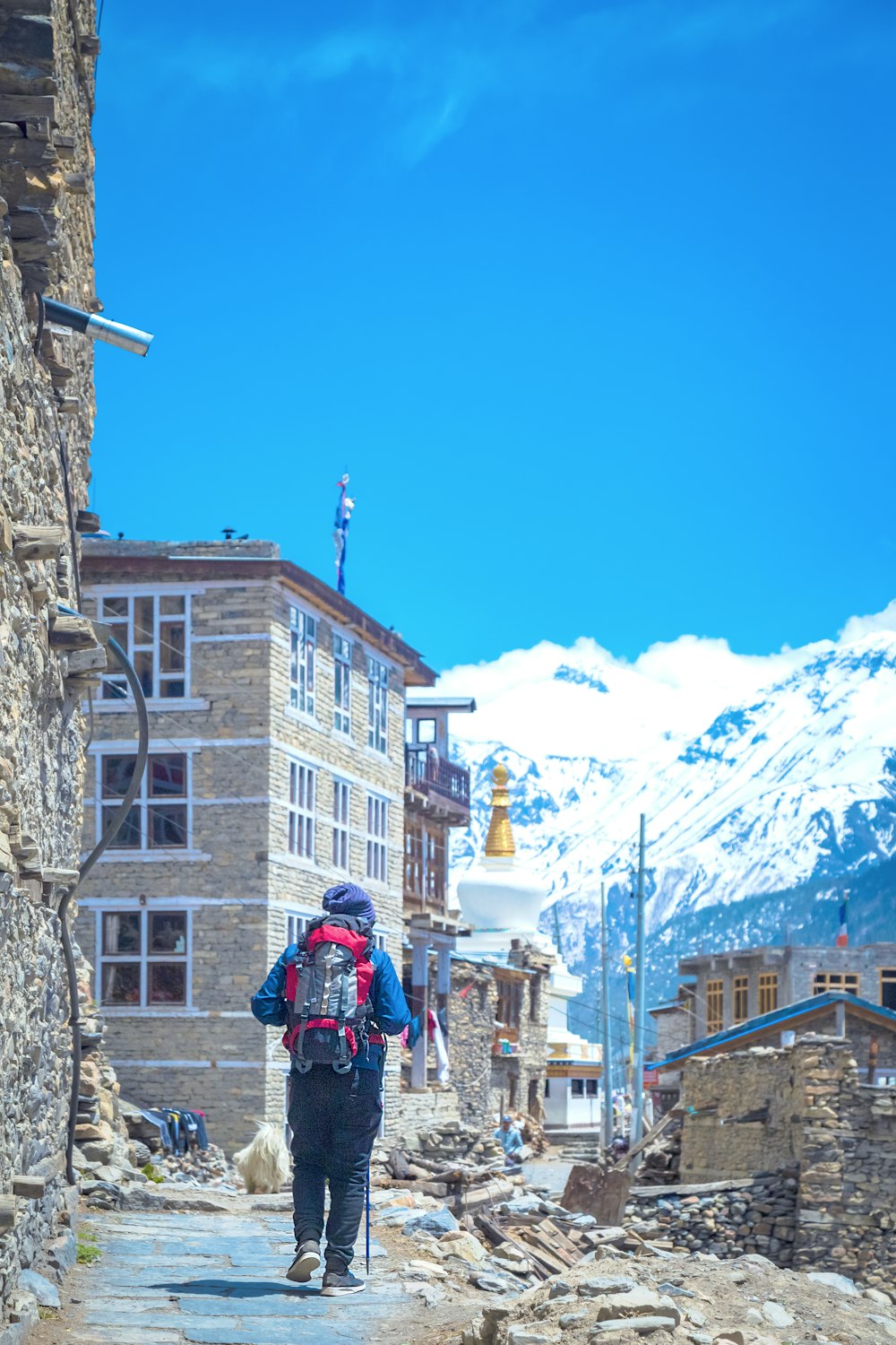 a person with a backpack walking down a street