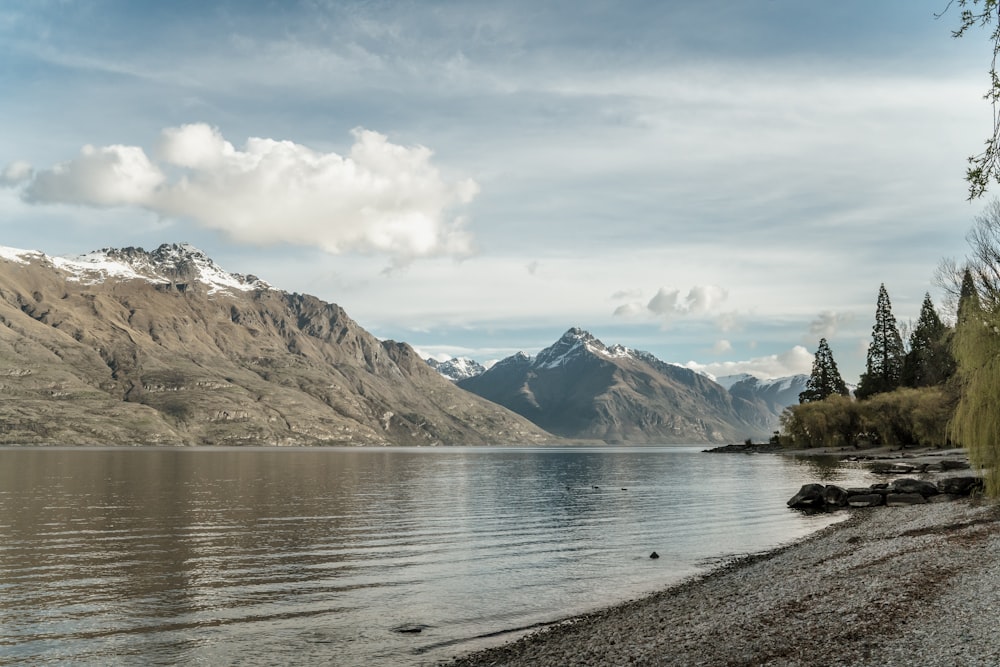 a body of water with mountains in the background