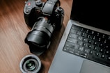 A high-quality camera placed on a wooden table.