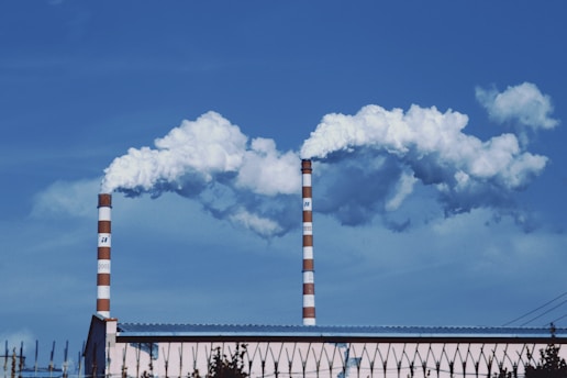 a factory with smoke coming out of it's stacks