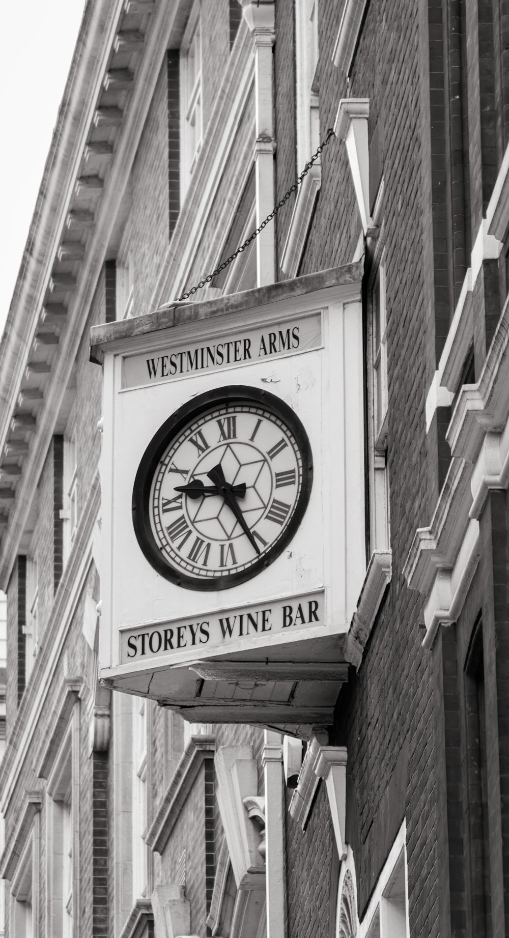 a clock hanging from the side of a building