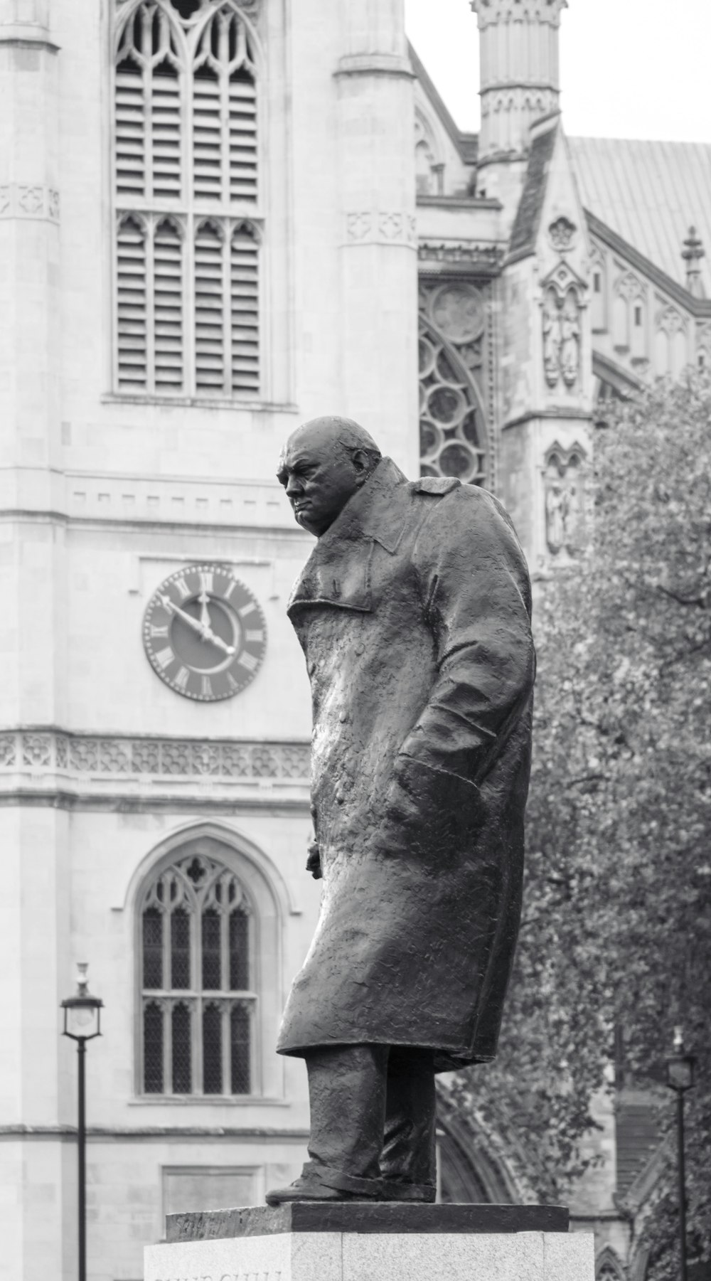 a black and white photo of a statue of a man