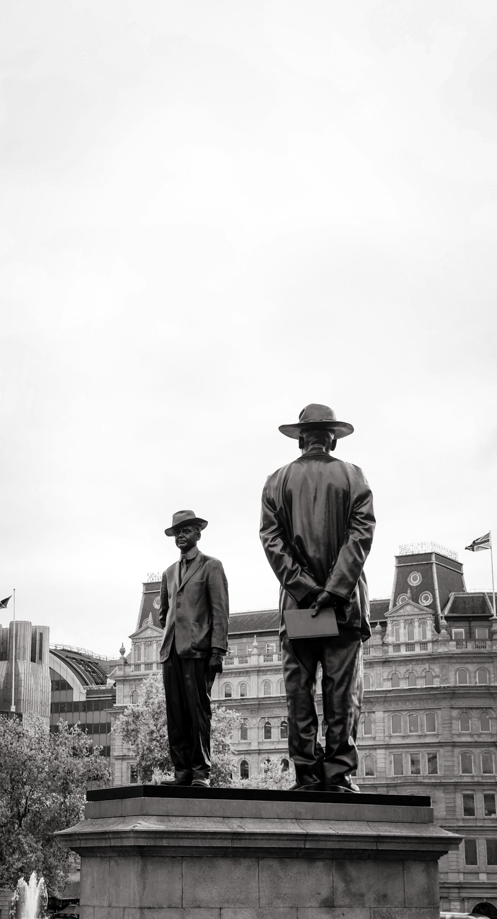 a statue of two men standing next to each other