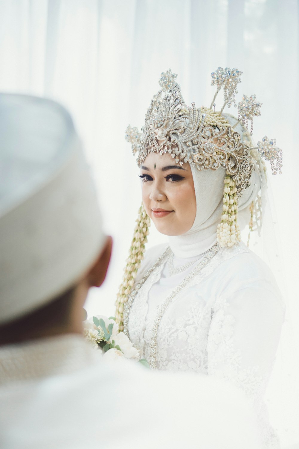 a woman in a white dress and a man in a white turban