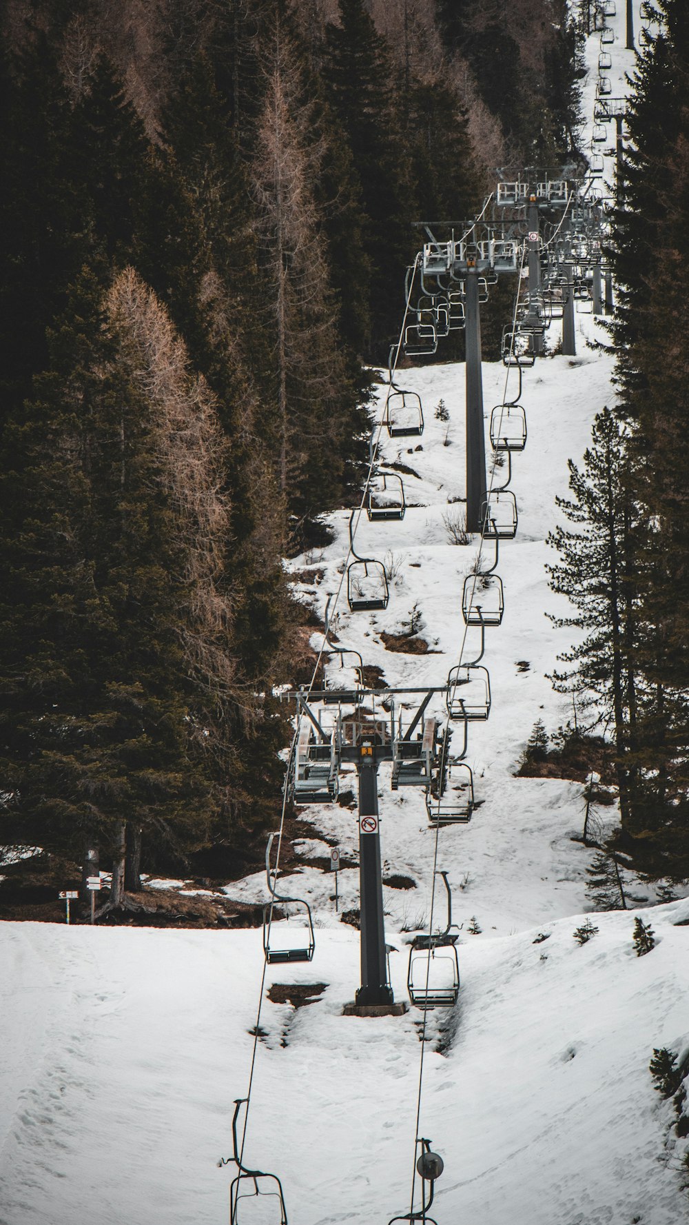 a ski lift going up a snowy mountain