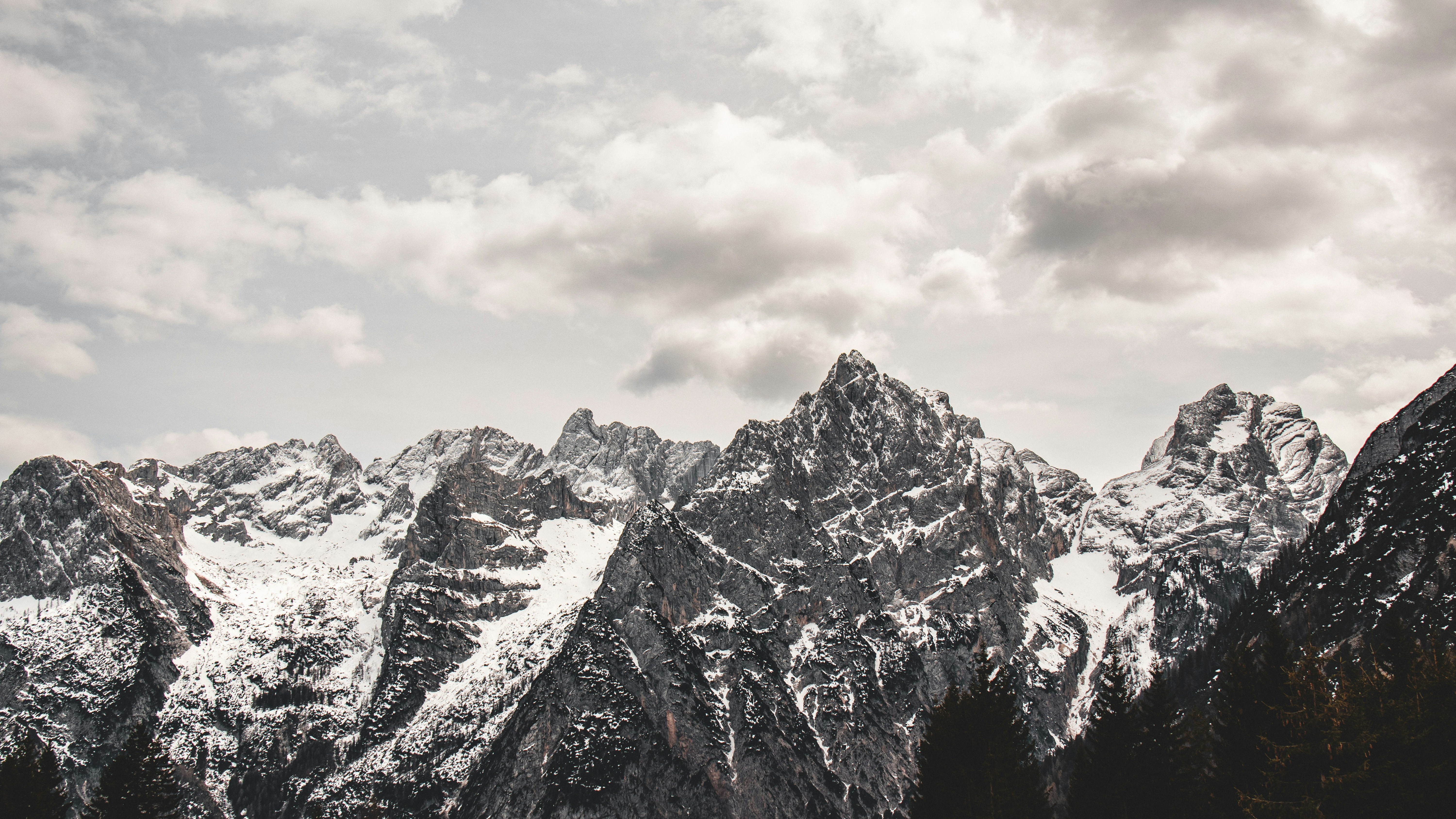 Snowy mountain range in the Dolomites under a cloudy winter sky