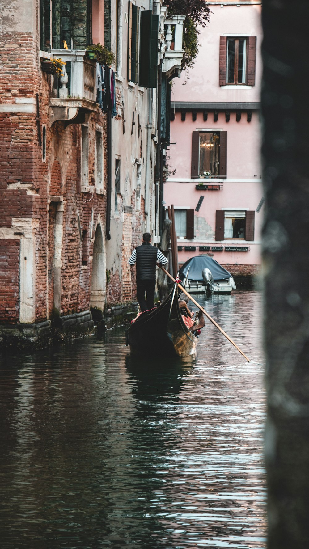 a man on a small boat in a canal