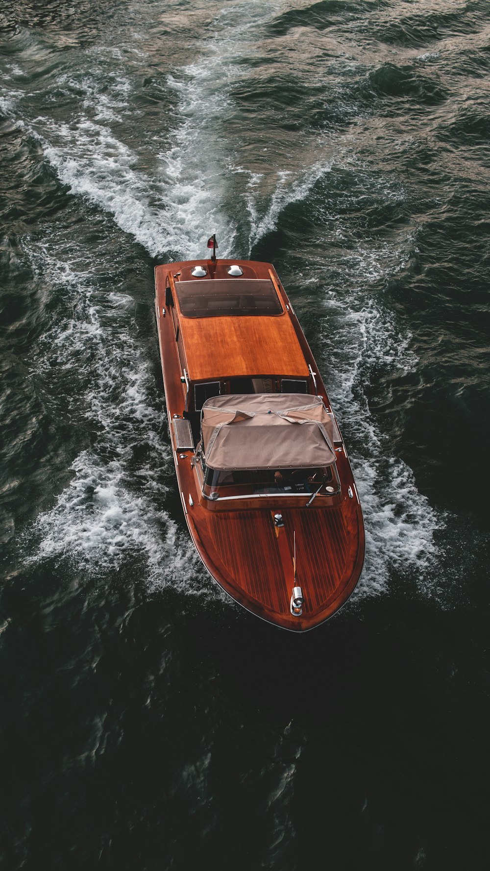 a small wooden boat in the middle of a body of water