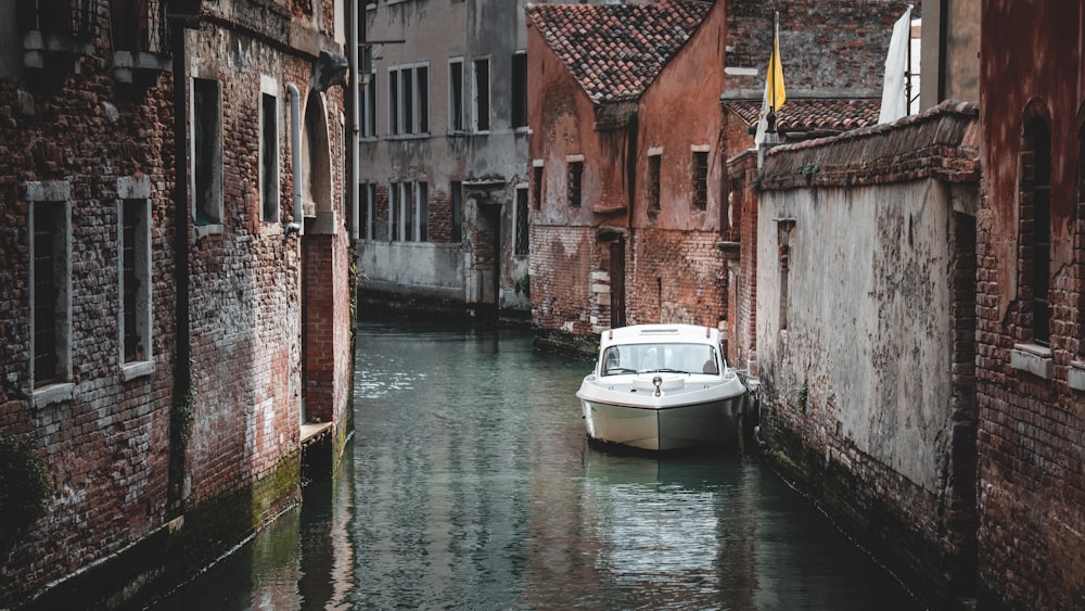 a boat is parked in a narrow canal