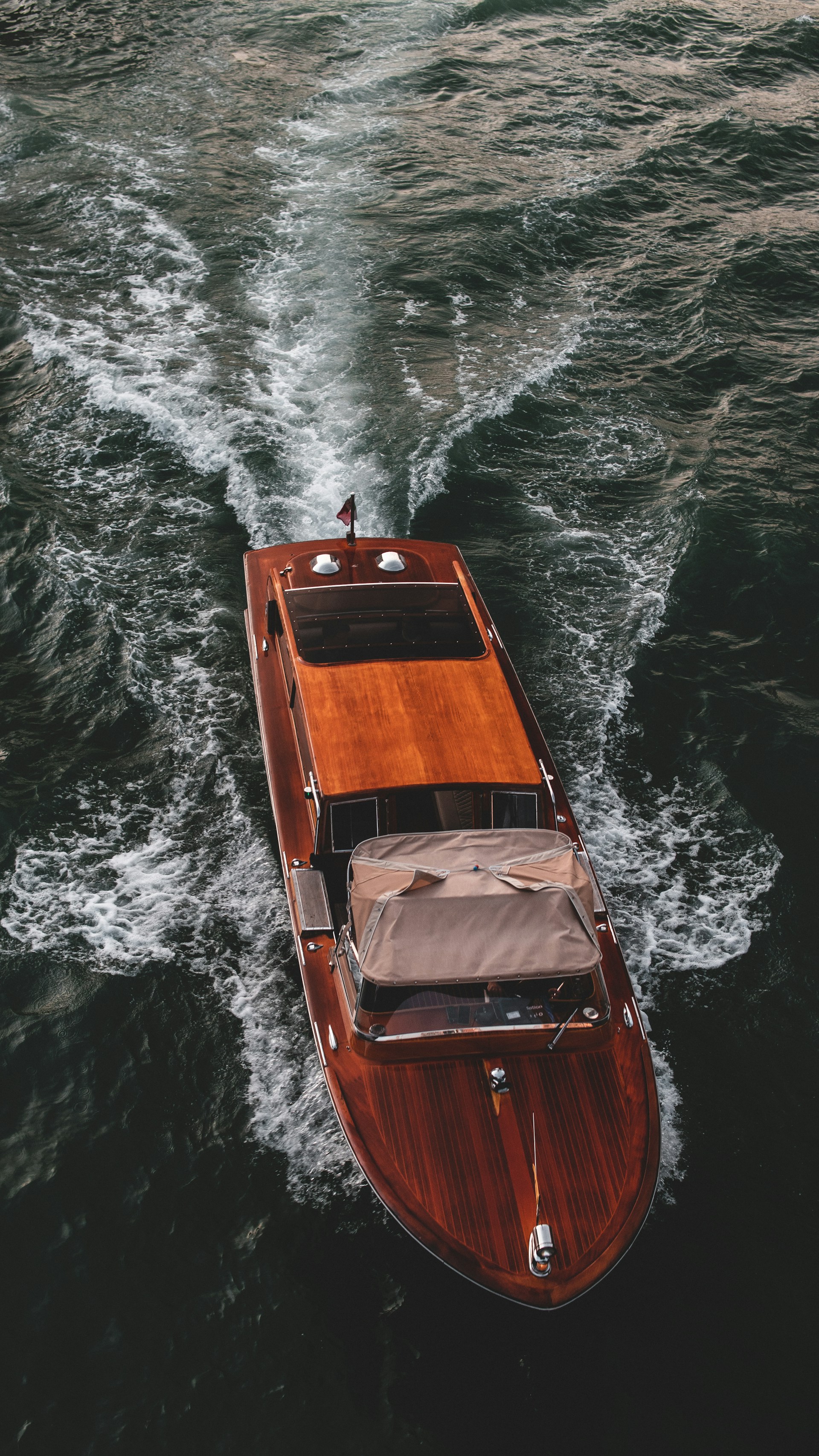 a small wooden boat in the middle of the ocean