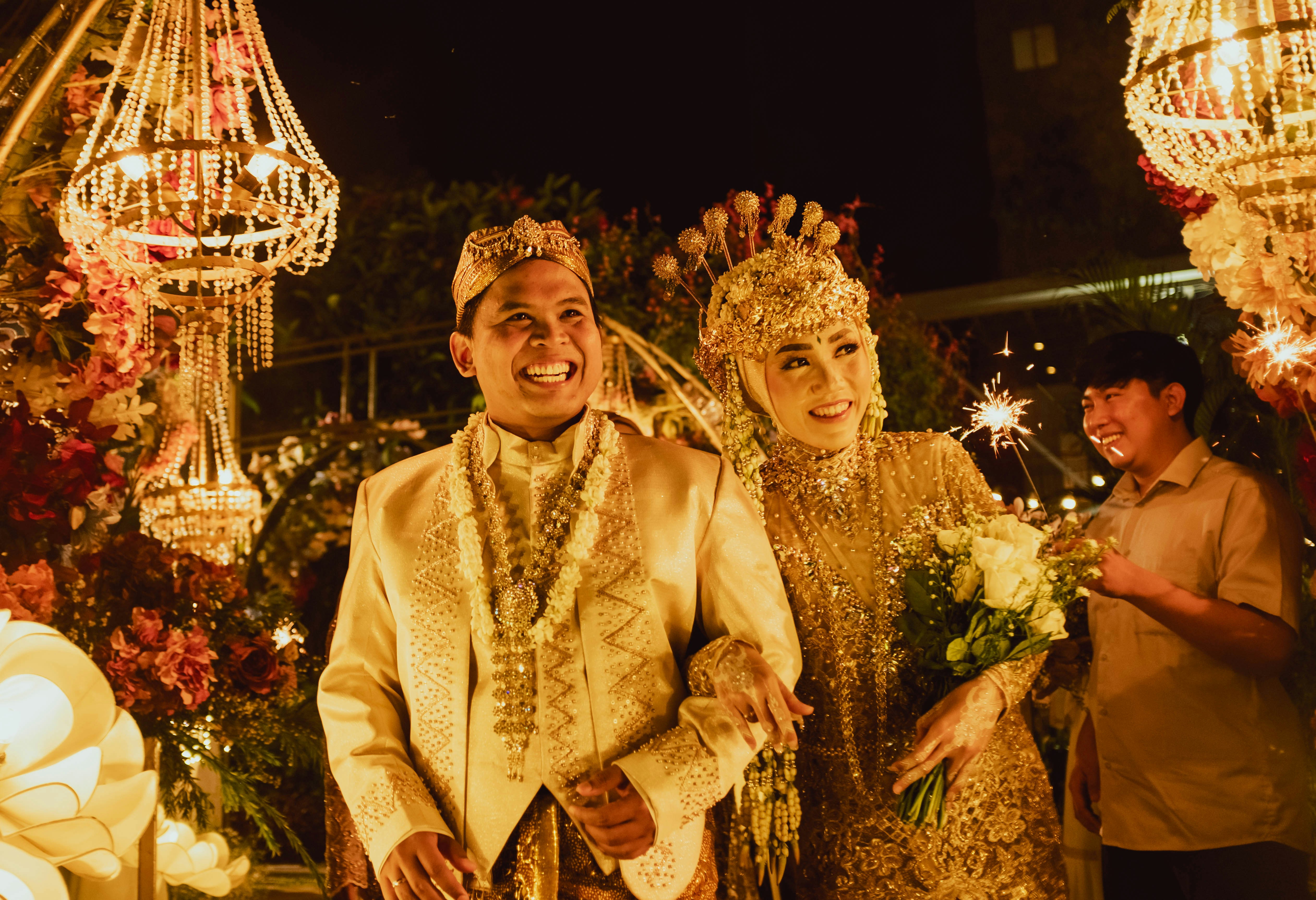 a man and a woman dressed in traditional thai garb