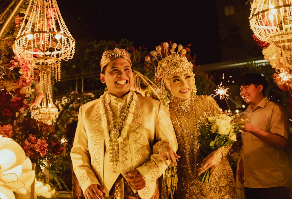 a man and a woman dressed in traditional thai garb