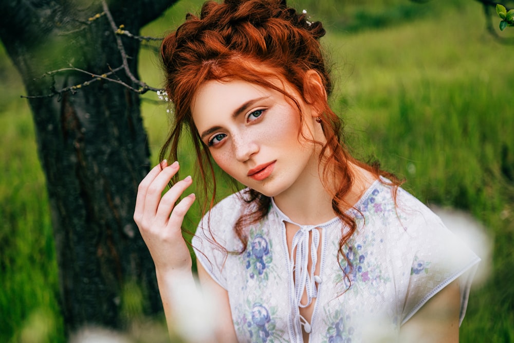 a woman with red hair is posing for a picture