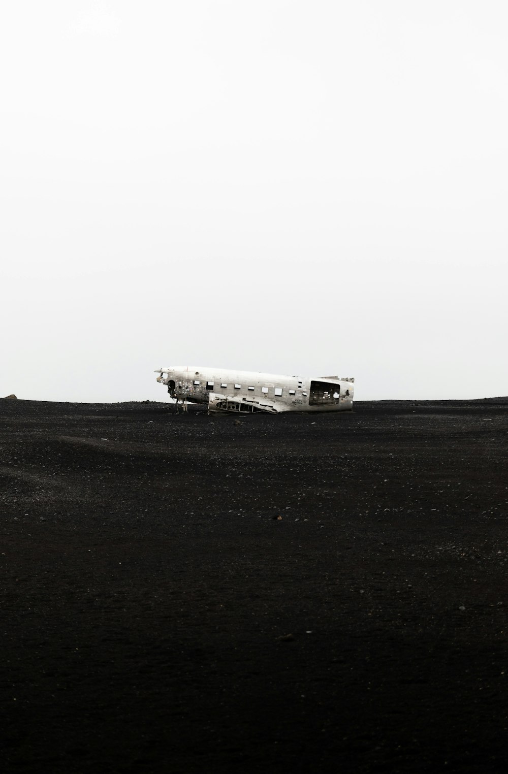 an airplane sitting on top of a black field