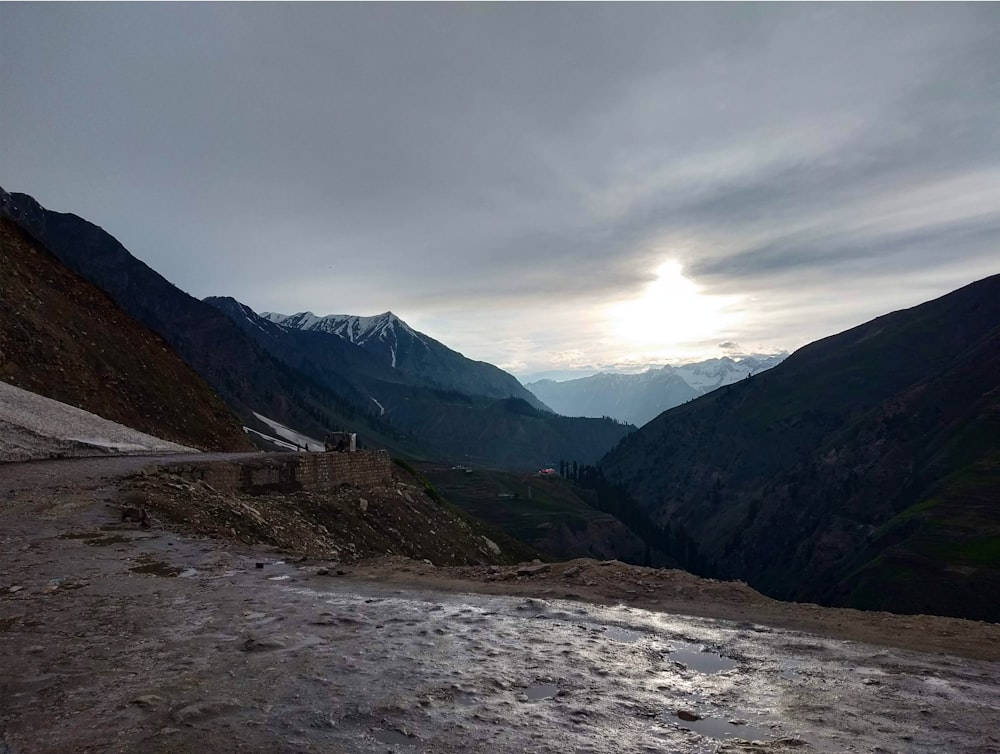 a view of a valley with mountains in the background