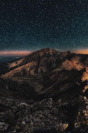 A stunning view of a starry night sky over a mountain range.