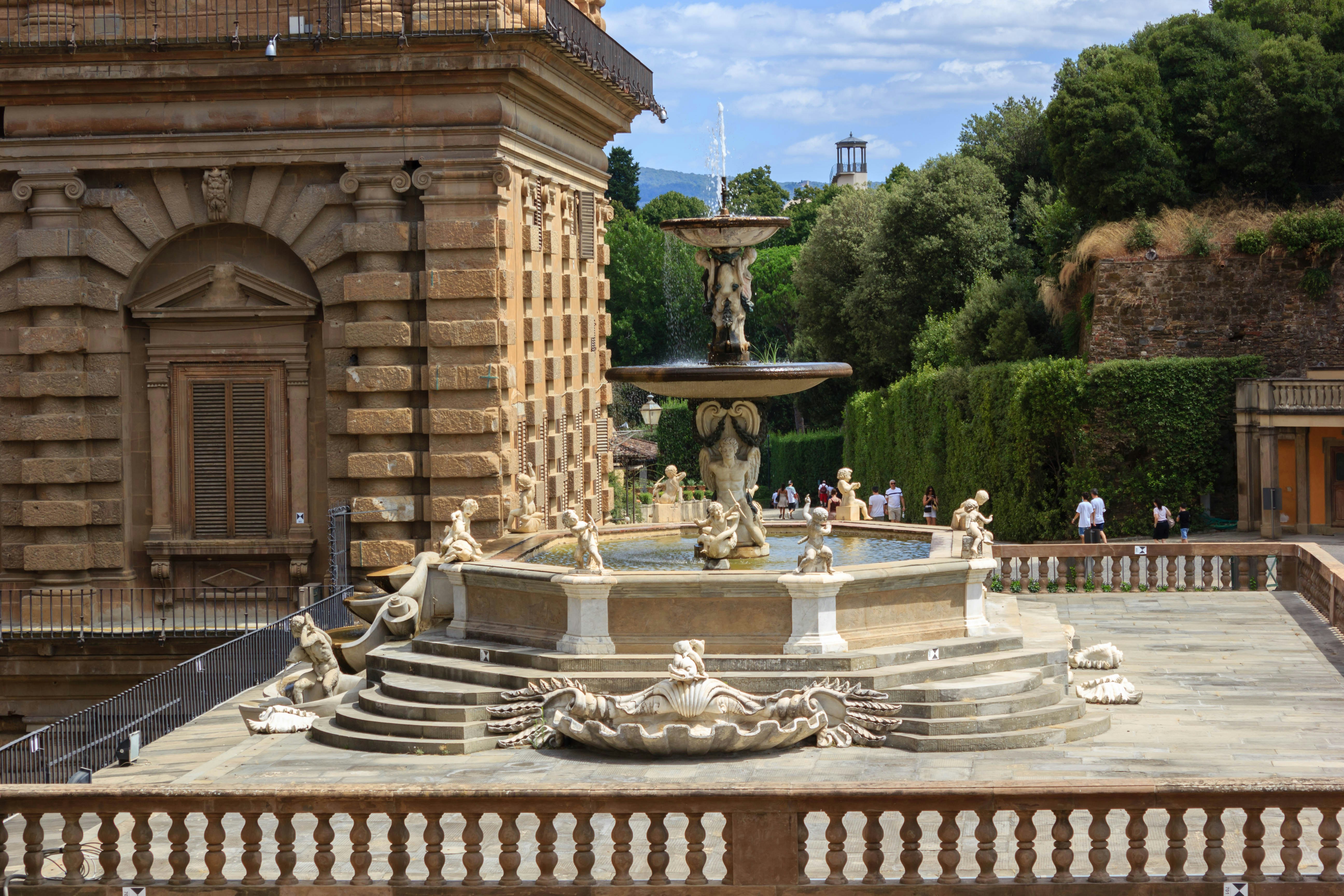 a fountain with statues in front of a building