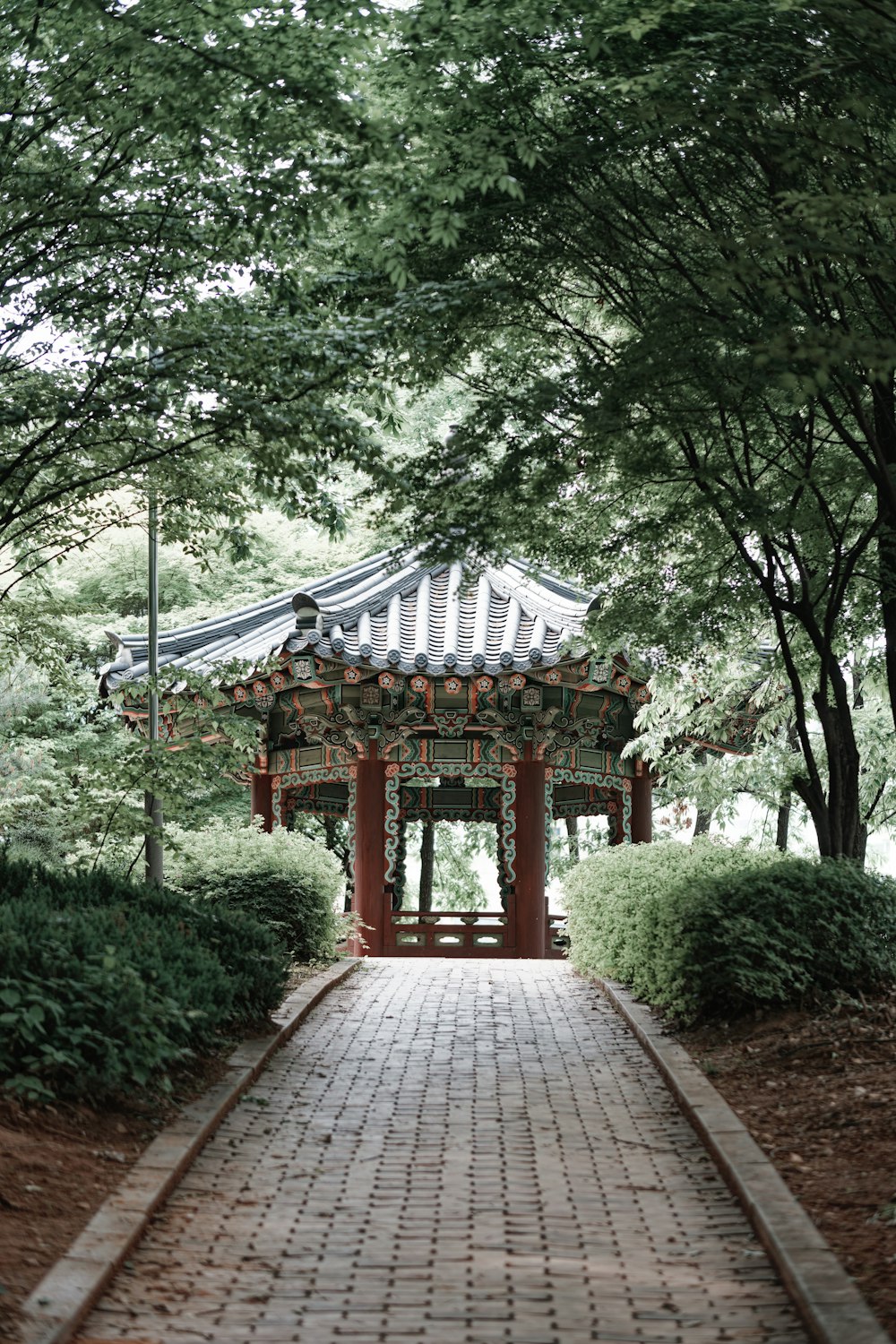a walkway leading to a pavilion in a park