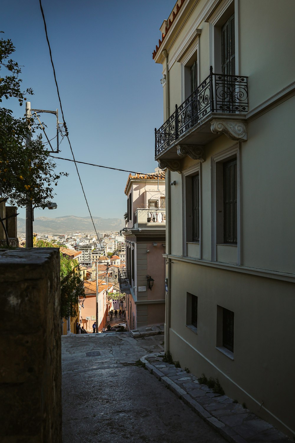 a narrow street with buildings and a street light