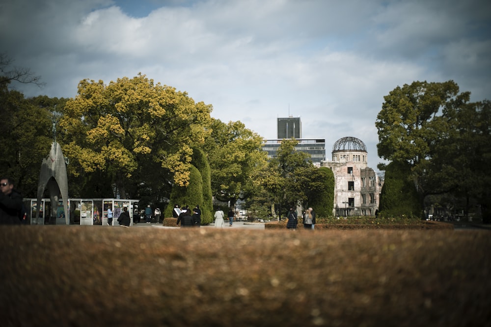 a group of people walking around a park