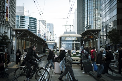 A busy urban street with commuters using public transport.