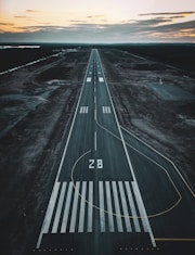 an aerial view of an airport runway at sunset