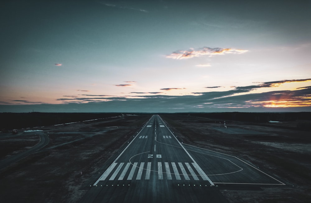 an aerial view of an airport runway at sunset