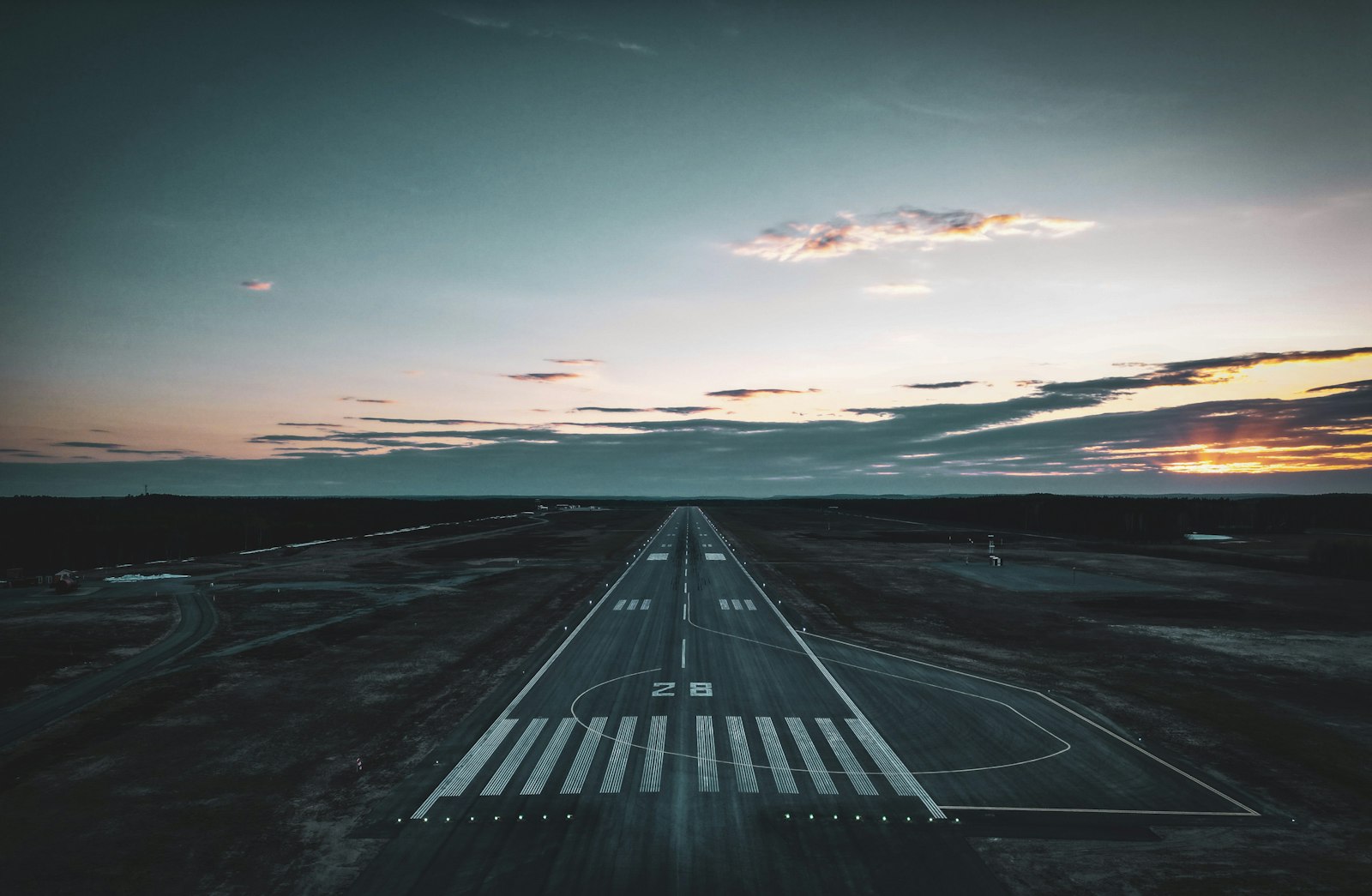 Airport runway at sunset — commitment to sustainable aviation