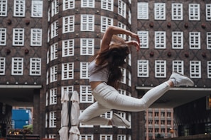 Dynamic shot of a person in Lumina Apparel activewear mid-motion on a city rooftop.