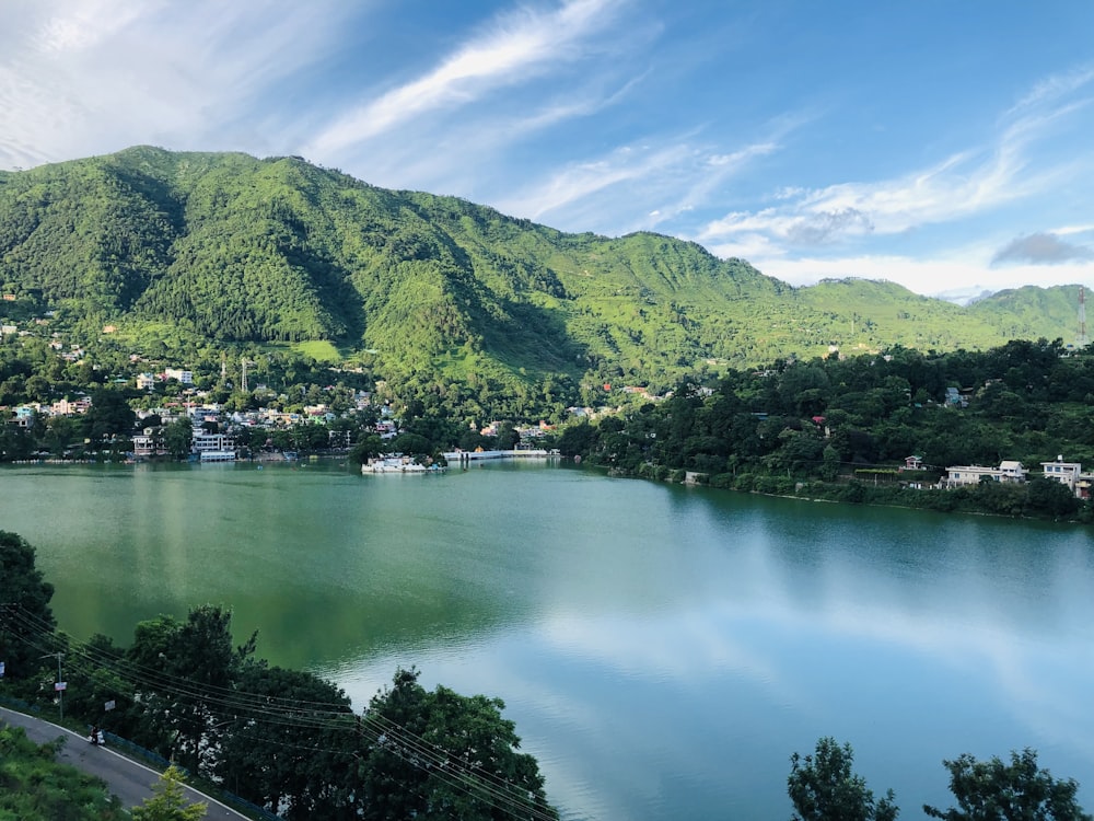 a large body of water surrounded by a lush green hillside