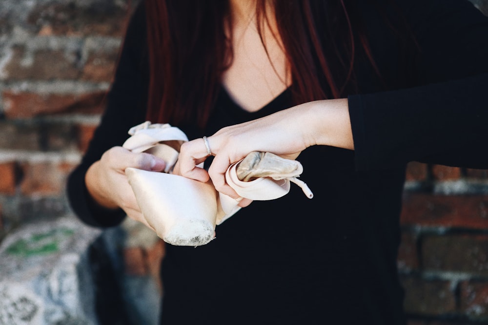 a woman holding a piece of food in her hands