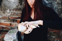 A woman holding a shell in her hands