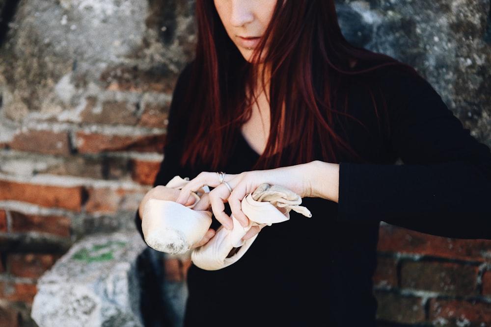 a woman holding a shell in her hands